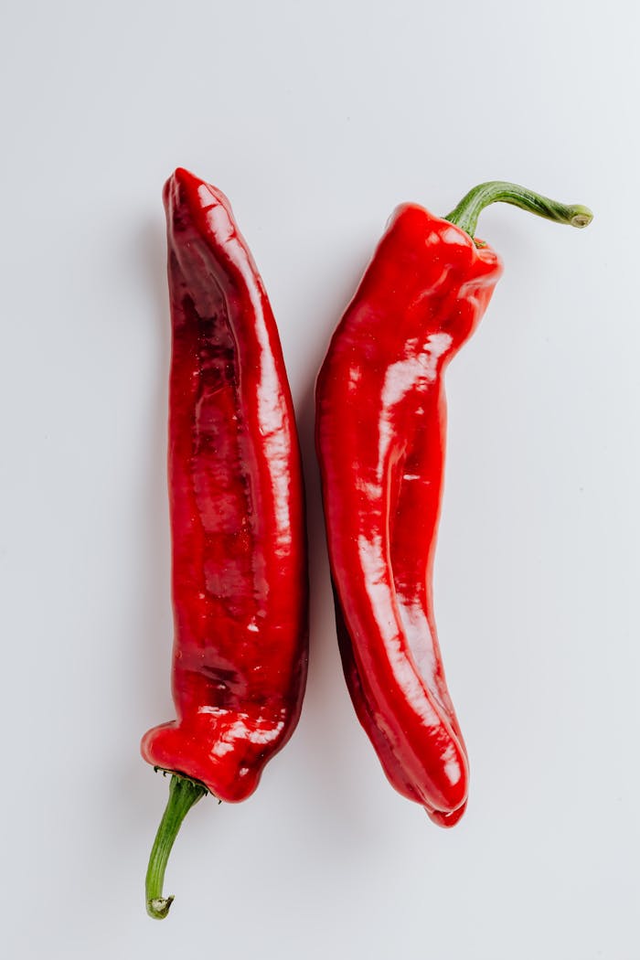 Close-up of fresh, hot red chili peppers showcasing vibrant color and spicy potential.